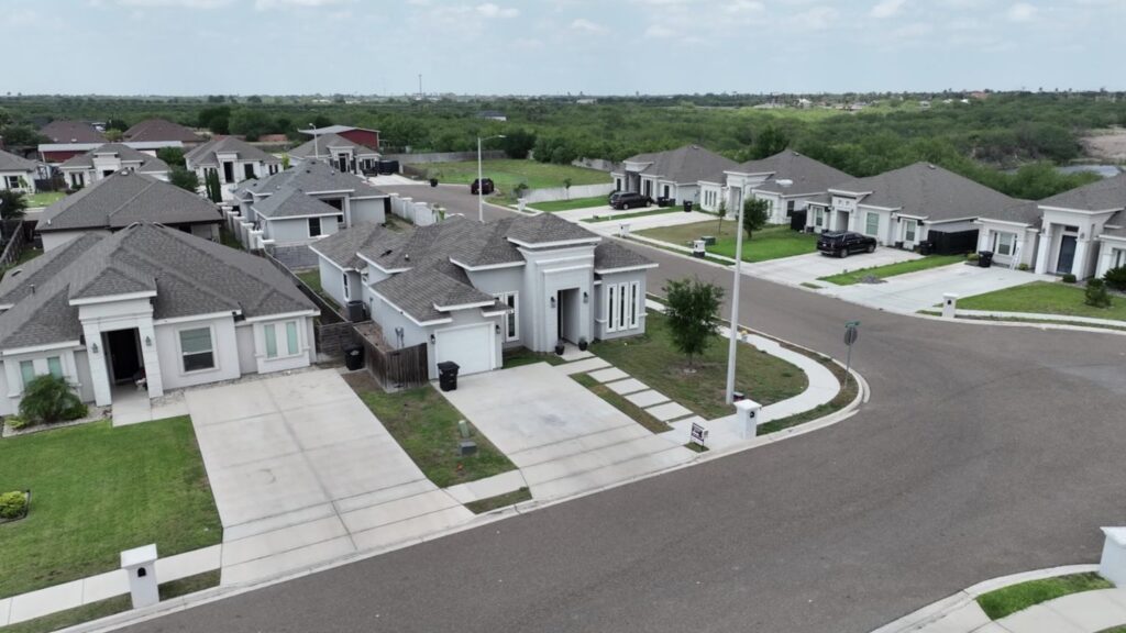 Aerial view of homes in the Comarex Subdision focusing on a corner lot home